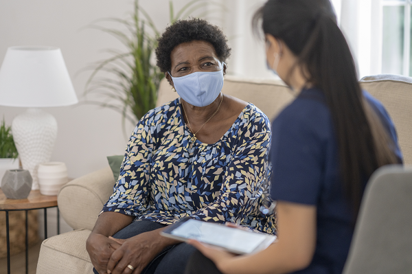 Healthcare professional reviewing patient information with her patient